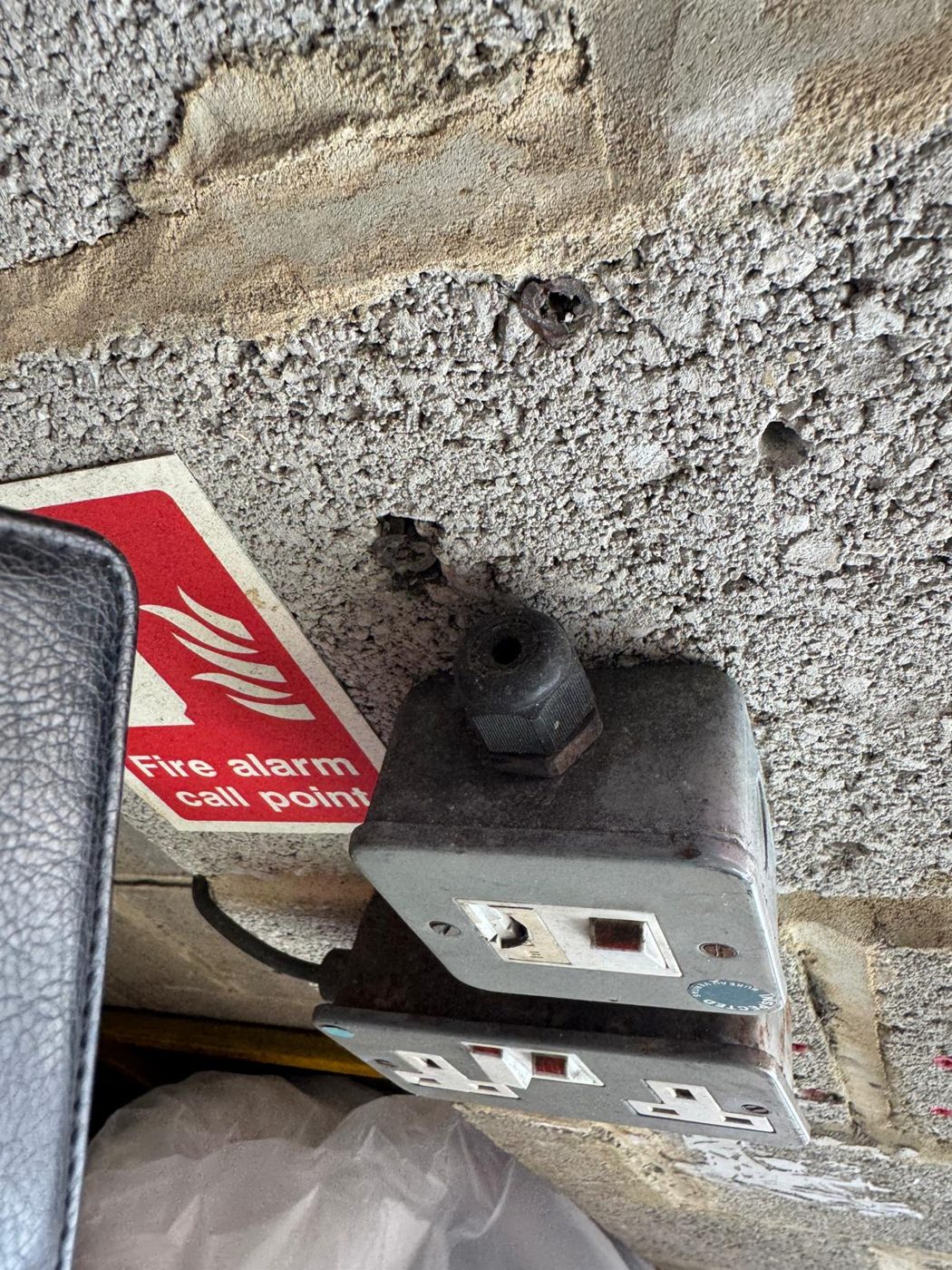 Damaged metal switched socket found during an EICR inspection, coded for remedial work
